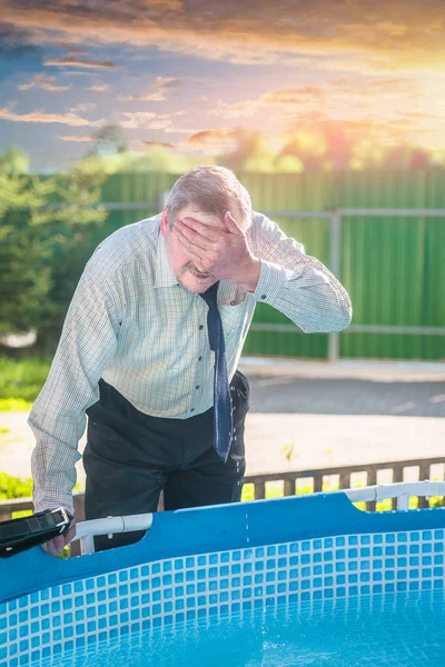 Male businessman with a briefcase washes your face out of the pool