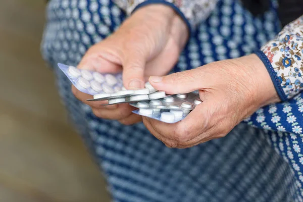 Pills, old age and the concept of health - pills in the hands of the old gum