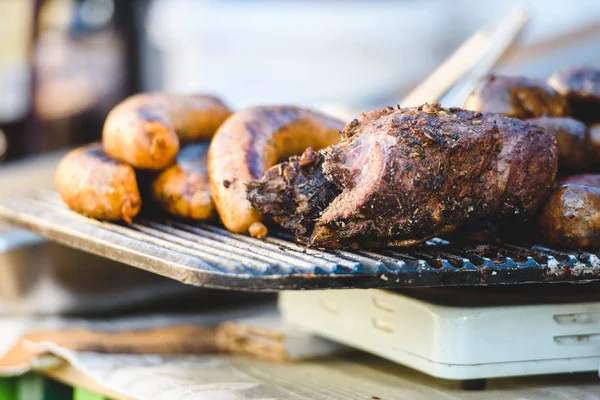 Meat delicacies and smoked meats on the market counter. Bushmeat. Sausages and pork