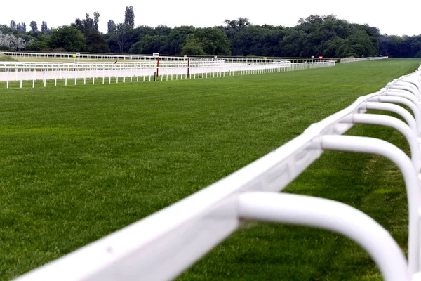 Empty racing track racecourse without horses and riders