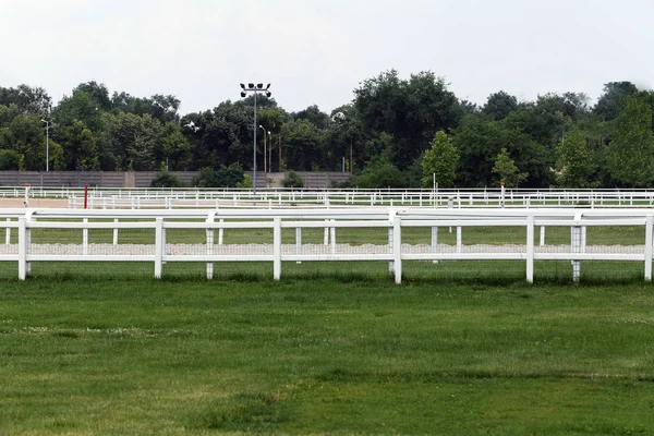 Empty racing track racecourse without horses and riders