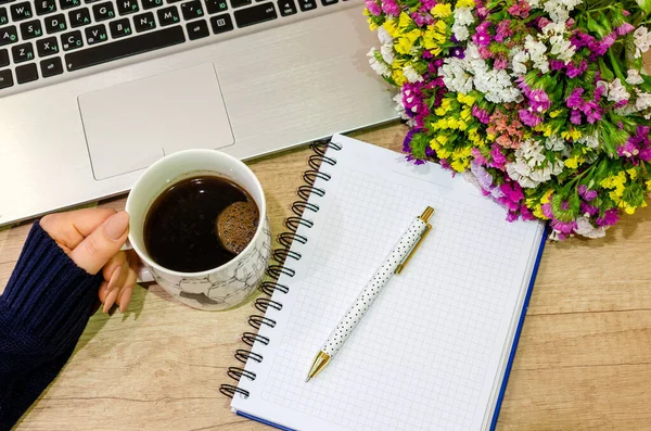 Ofis masası manzaralı. Ahşap masa, bilgisayar, defter, çiçek, kalem ve elma..