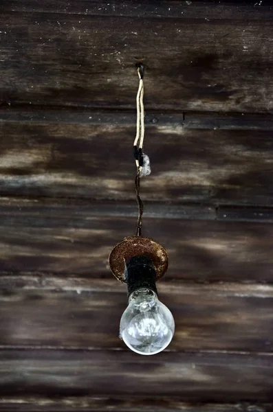 light bulb hanging on the background of the boards