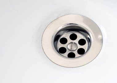 Silver Plug Hole on White Ceramic Bath clipart