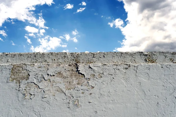 Bulutlu mavi gökyüzü ile beyaz tuğla duvar — Stok fotoğraf