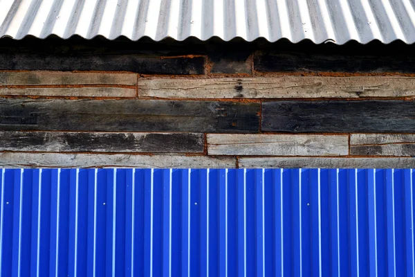 Blue Metal Fence Wood House and Roof