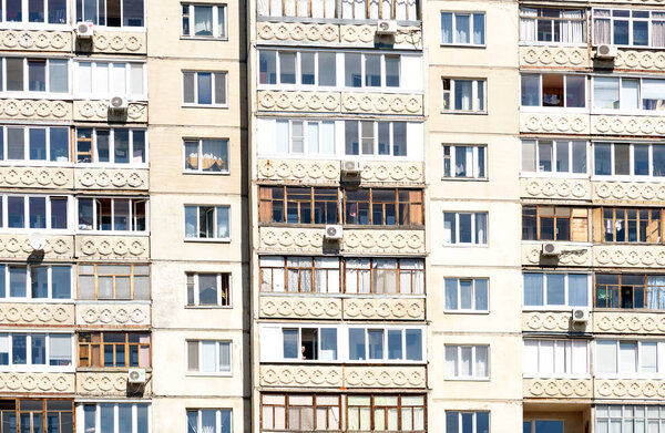 Apartment Building exterior windows in a repeating vertical pattern in natural sunlight for architectural concepts and designs