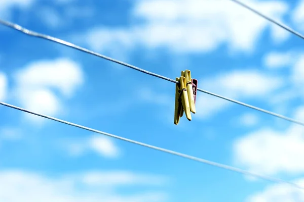 Three Plastic Clothes pegs on a Washing Line — Stock Photo, Image