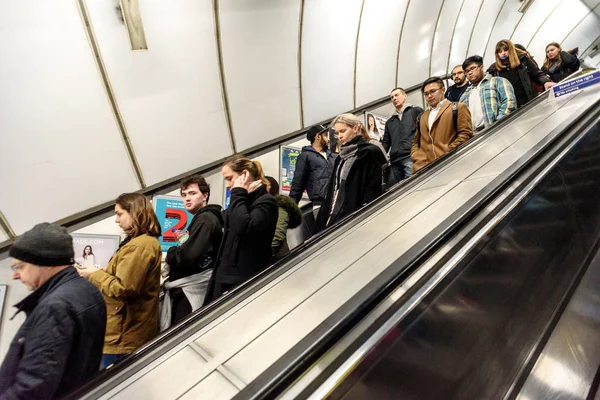Mensen rijden een Londense ondergrondse buis roltrap — Stockfoto