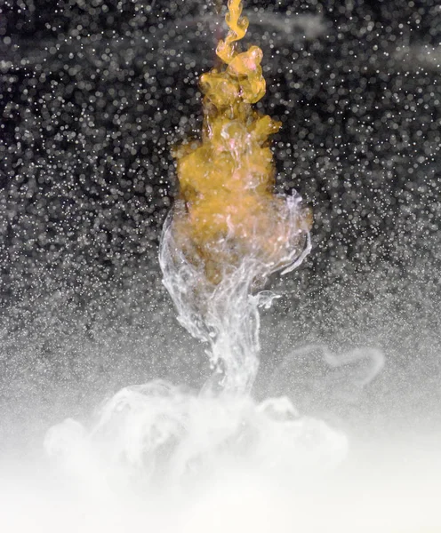 White Liquid Drops in Water Stock Image