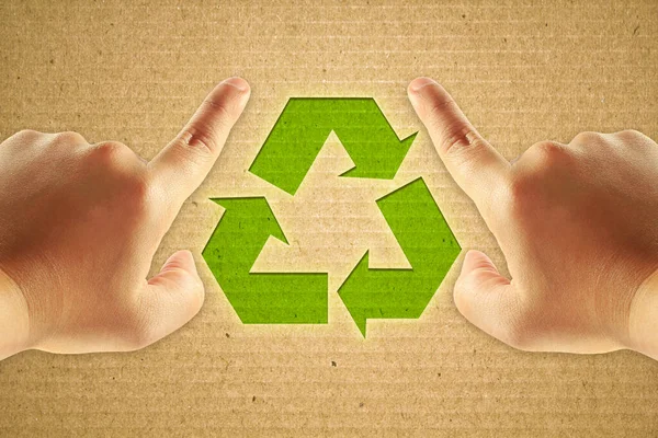 人間の手のフォーカスポイントと段ボールのリサイクル緑のシンボル — ストック写真
