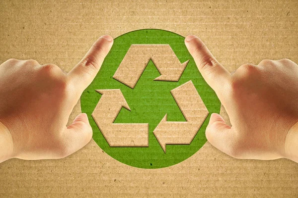 人間の手のフォーカスポイントと段ボールのリサイクル緑のシンボル — ストック写真