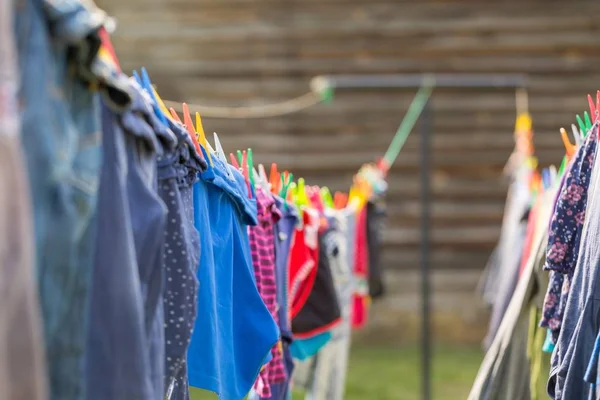 Washing line with drying clothes in outdoor. Clothes hanging on washing line in outdoor.
