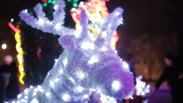 Lighted Santa Clauss Reindeer Against Christmas Tree Stock Video