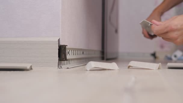 The installation of skirting in the room on the wall. — Stock Footage The installation of skirting in the room on the wall. Royalty Free Stock Footage