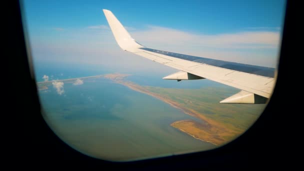 Plane taking off from airport, View through an airplane window — Stock Video