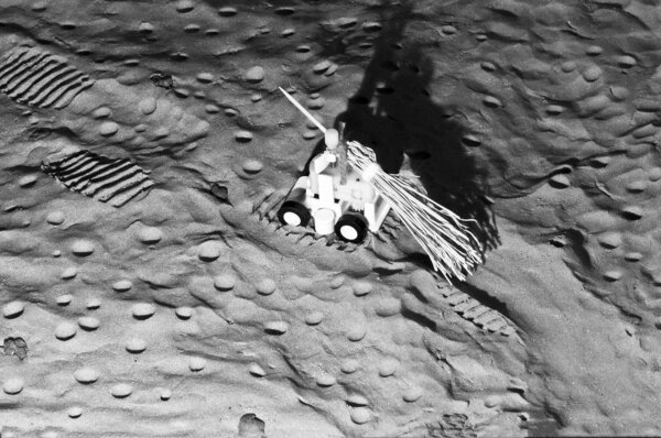Moon rover covering the astronauts' tracks on lunar soil