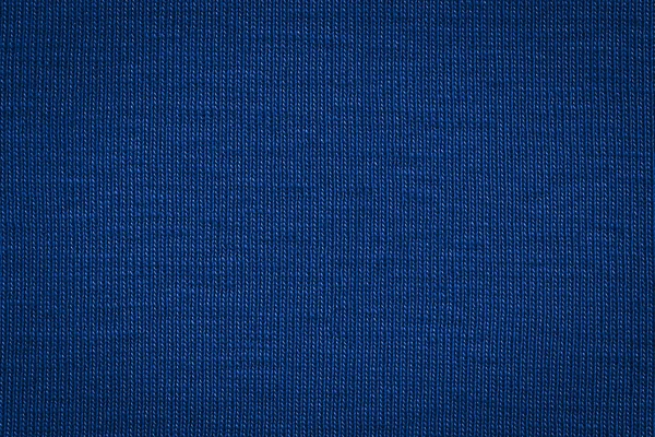 Texture of real dark blue knitwear, textile background.