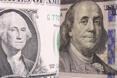 US President Washington on a bent 1 dollar bill. Close-up. Against the backdrop of President Franklin on a 100-dollar bill.