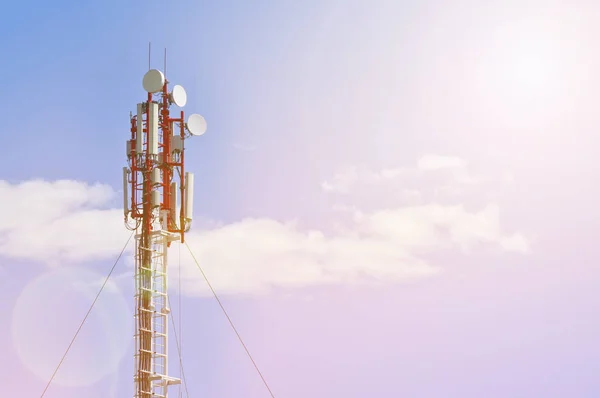 Cellular antenna against blue sky in sunset light with copy space. Concept of modern business communication.