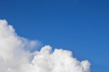 Kümülüs bulutları mavi gökyüzüne karşı. Eşsiz doğal arka plan. Kopyalama alanı ile