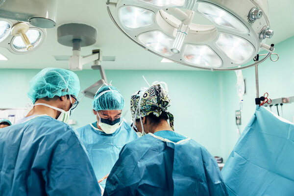 Team of Surgeons Operating.