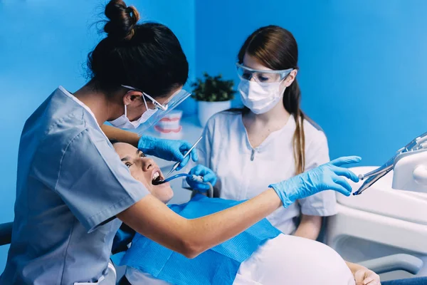 Dentists with a patient during a dental intervention. Dentist Concept