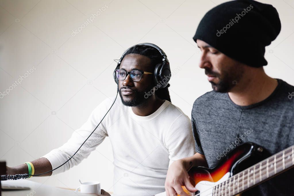 Artists producing music in their home sound studio.