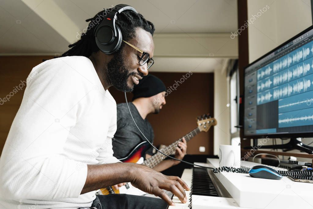 Artists producing music in their home sound studio.