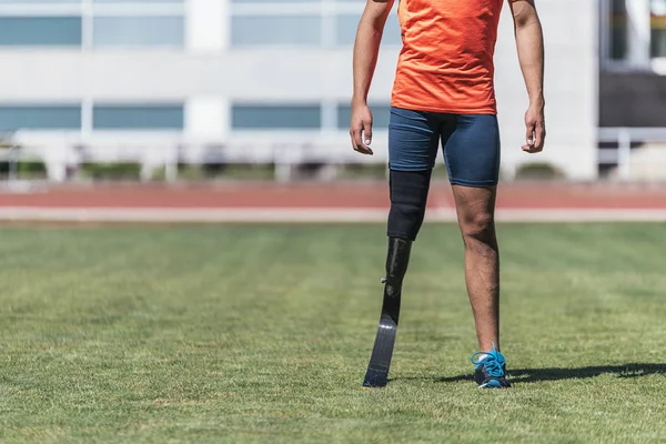 Close up disabled man athlete with leg prosthesis. Disabled Sport Concept.