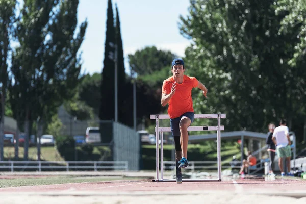 Disabled man athlete training with leg prosthesis. Disabled Sport Concept