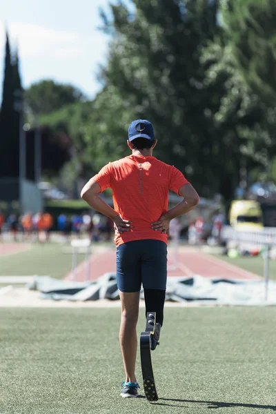 Disabled man athlete training with leg prosthesis. Disabled Sport Concept