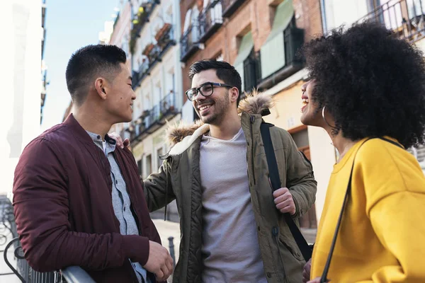 Group of happy friends chatting in the street. Friendship concept.