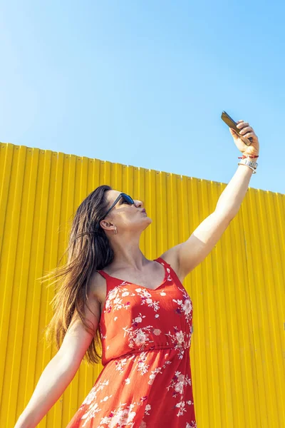 Self portrait of beautiful young woman making peace sign. Selfie Concept