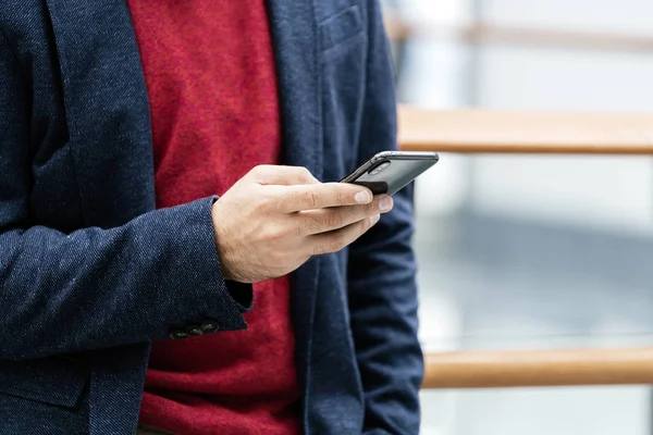 Unrecognizable Trendy Hipster Blue Jacket Using Smartphone Indoors — Stock Photo, Image