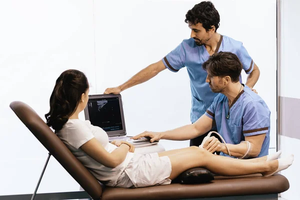 Physiotherapist giving knee therapy to a woman