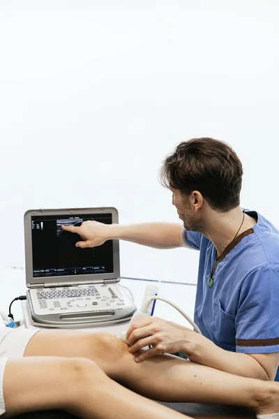 Physiotherapist giving knee therapy to a woman