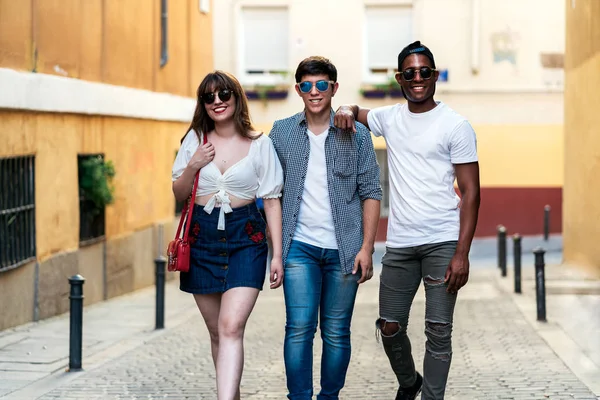 Multiraciale stijlvolle jonge mensen lopen op straat — Stockfoto