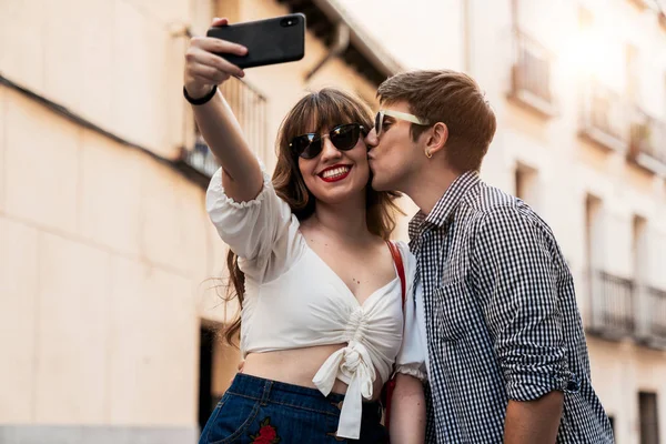 Άνθρωπος φιλιά χαμογελαστή γυναίκα παίρνοντας selfie στο δρόμο — Φωτογραφία Αρχείου