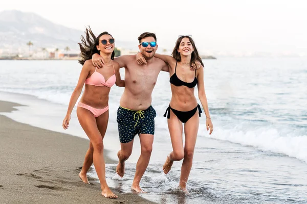 Примушувати друзів ходити на піщаному пляжі разом — стокове фото