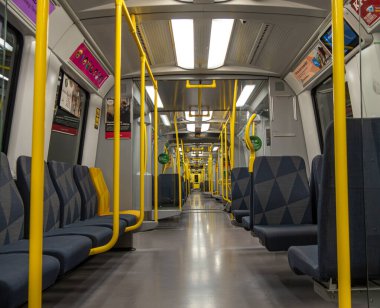 Stockholm, İsveç - 9 Haziran 2025: Sarı direkli ve mavi koltuklu içi boş metro treni. Burası Stockholm..