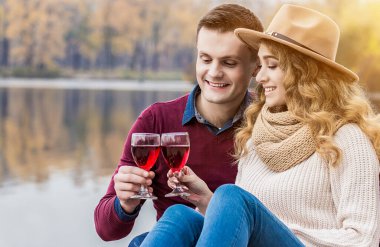 - Şerefe. İlk yıl dönümlerini kutluyorlar. Genç ve güzel bir çiftin plajda romantik bir akşam yemeği yerken kadeh tokuşturup gülümsemesinin portresi. Erkek kadını kucaklıyor ve şarap içiyor.