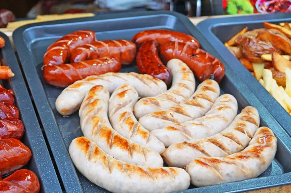 Güneşli bir günde fuarda tezgahta ızgara sosis, ev yapımı sosis ve kupaty