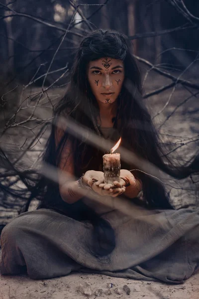 woman holding candle in hands close up