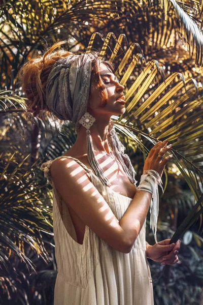 Bela jovem mulher na moda em turbante posando ao ar livre — Fotografia de Stock