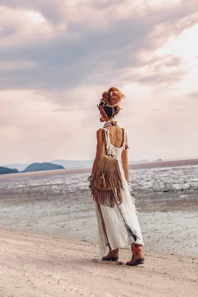 Όμορφη νεαρή boho γυναίκα με τα πόδια στην παραλία στο ηλιοβασίλεμα — Φωτογραφία Αρχείου