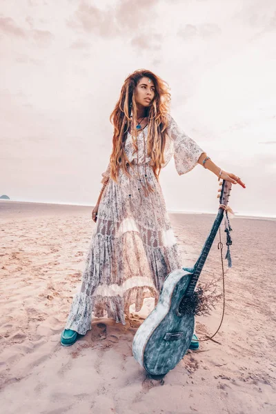 Schöne junge Mode-Modell in weißem Kleid mit Gitarre im Freien — Stockfoto