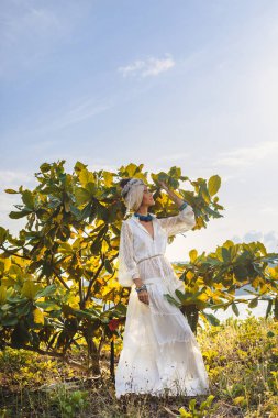türban ve beyaz elbise giyen güzel genç boho kadın 