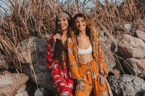 Dos modelos boho alegres y elegantes al aire libre al atardecer — Foto de Stock