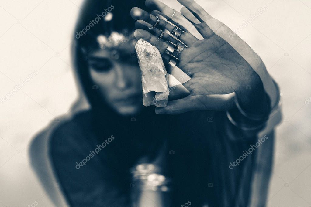 close up of woman holding magic stone. black and white. 